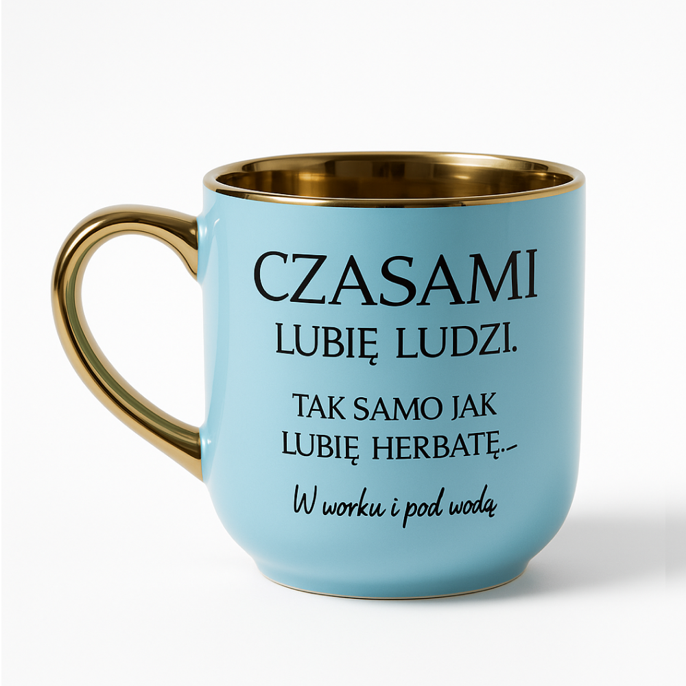 Błękitny kubek ze złotym uchem i złotym wnętrzem, ozdobiony humorystycznym napisem: ‘Czasami lubię ludzi. Tak samo jak lubię herbatę — w worku i pod wodą’